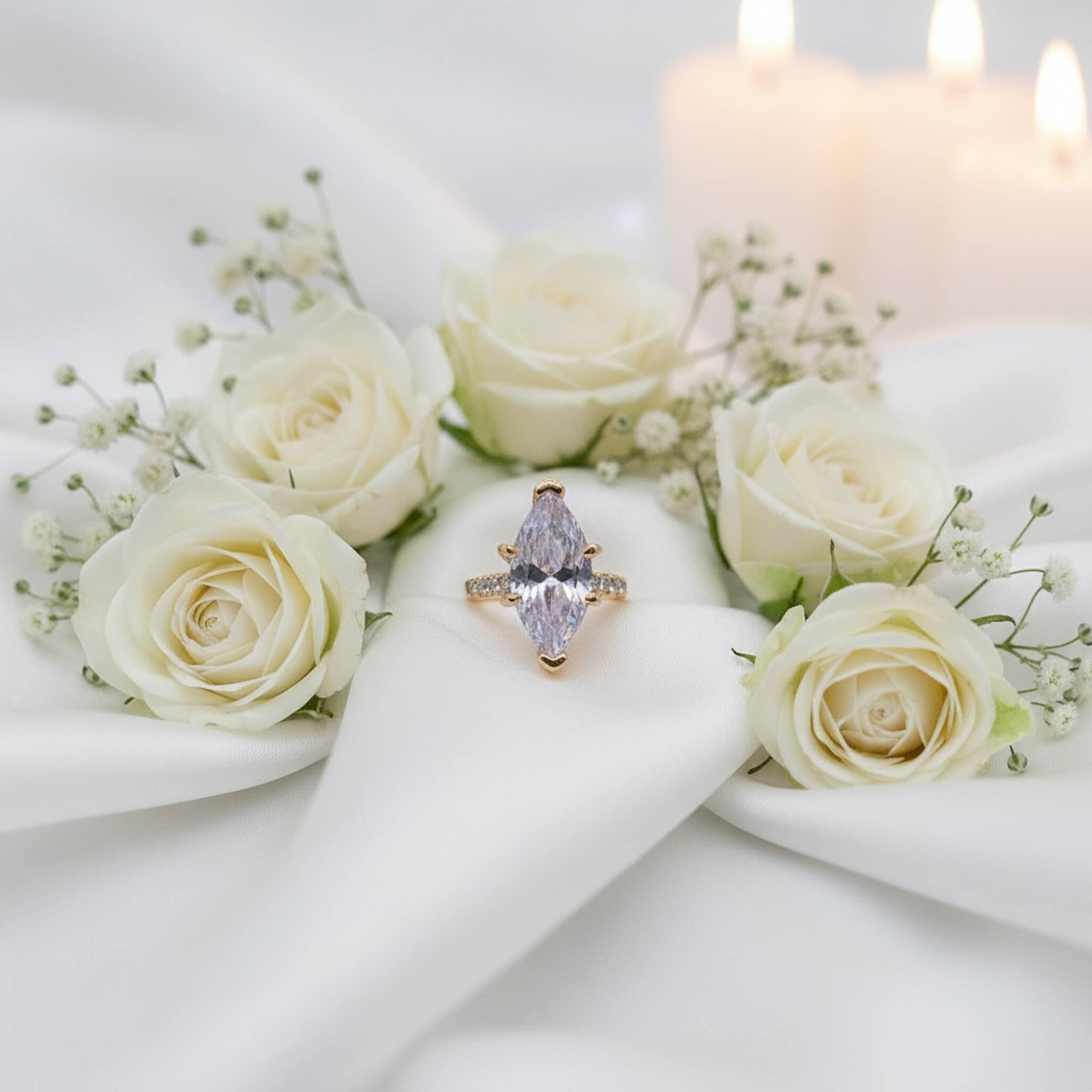 Anillo de compromiso marquesa en Oro 10K presentado sobre fondo decorativo, ideal para propuesta de matrimonio. TuOro.