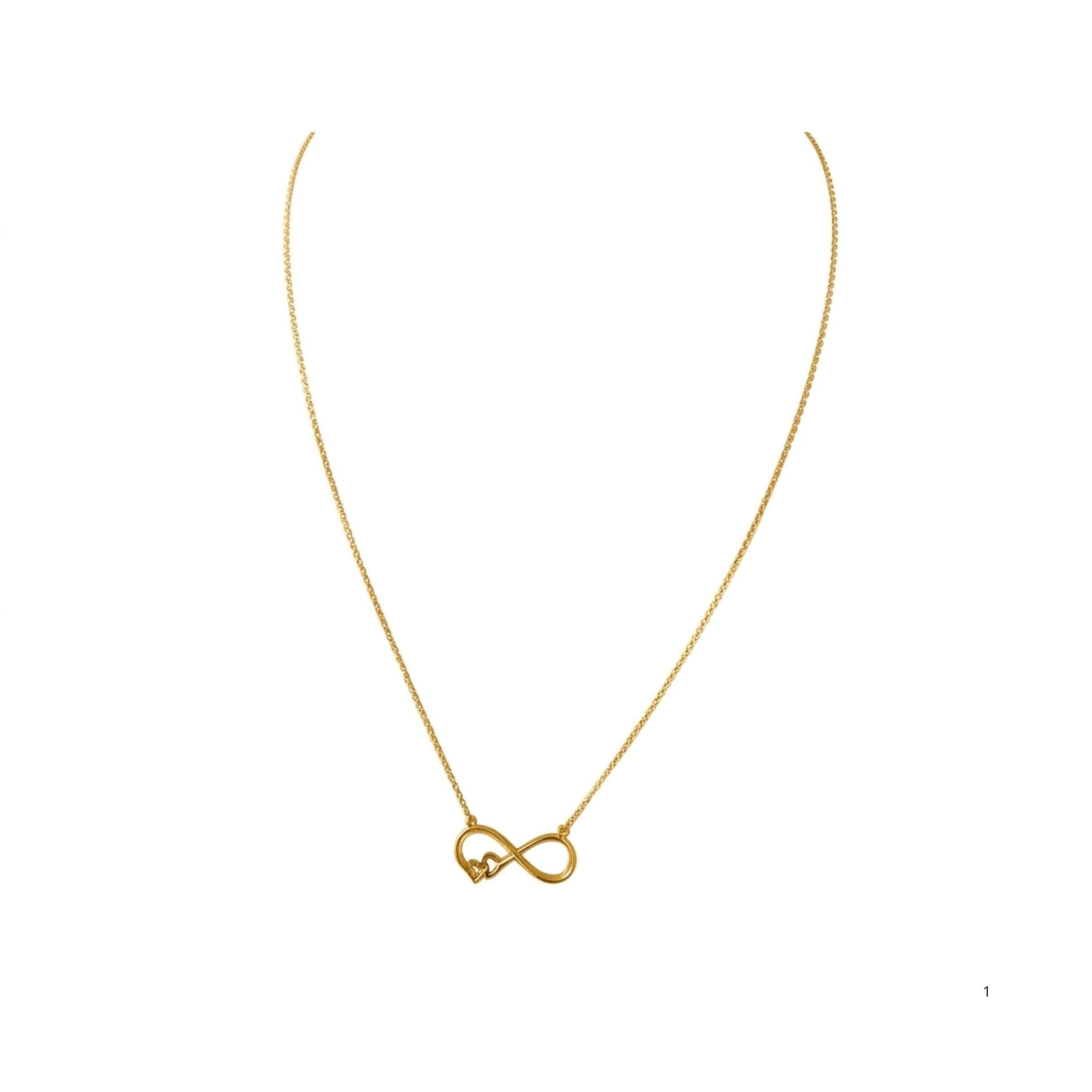 Cadena fina de oro 10K TuOro con dije de infinito decorado con un pequeño corazón sobre fondo blanco.